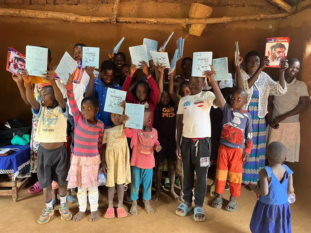 Group of children in Bumbo village with learning materials